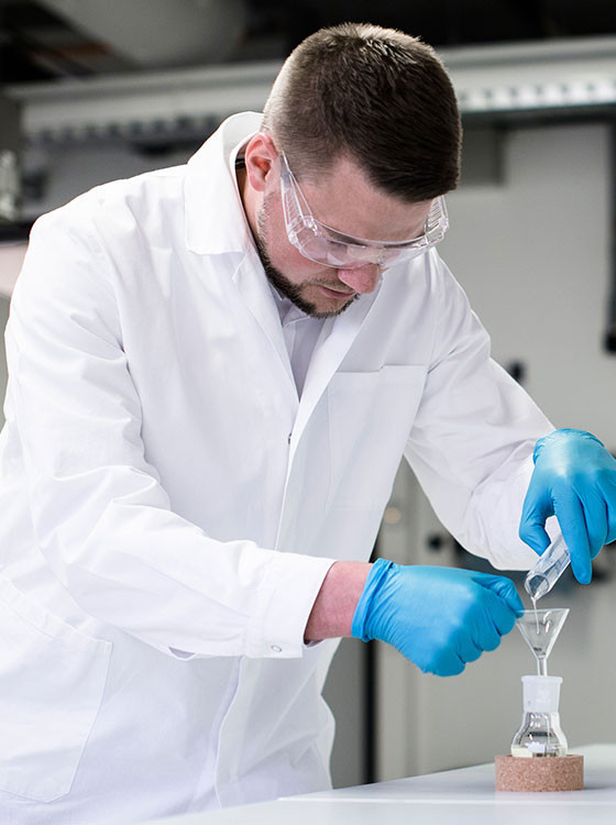 Man in laboratory working with liquids