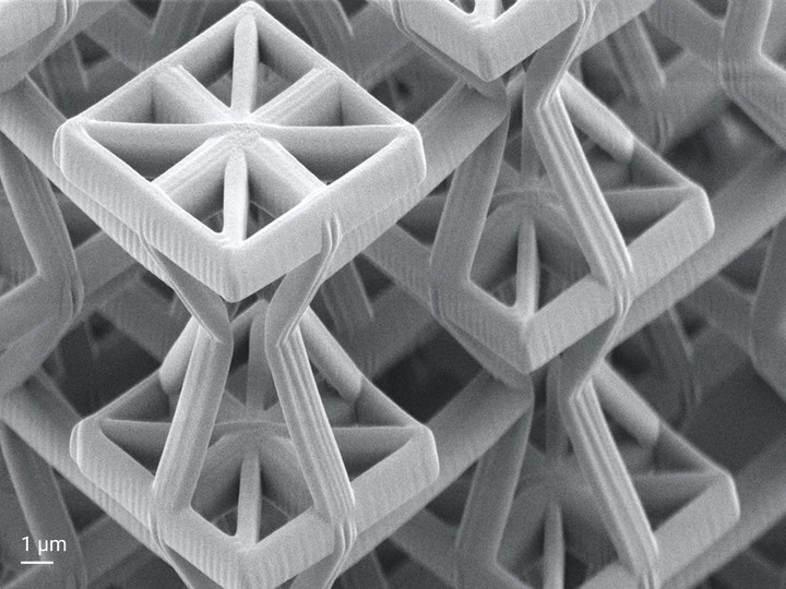 Auxetic metamaterial with a negative Poisson's ratio that laterally expands when stretched and shrinks when compressed.